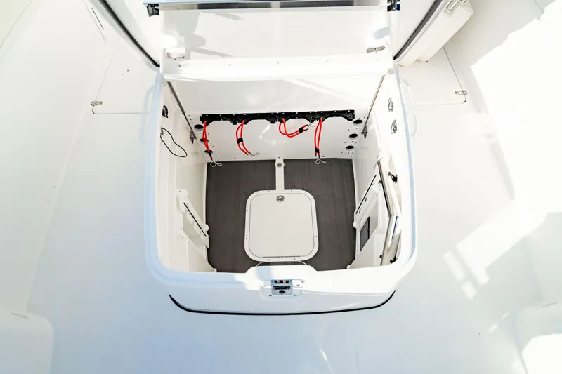 Slide: The Image of 2024 Edgewater 340CC boat storage compartment with open hatch, showcasing interior details. - 9