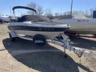 Slide: The Image of 2005 Sea Ray 185 Bow Rider boat on trailer, parked outdoors. - 1