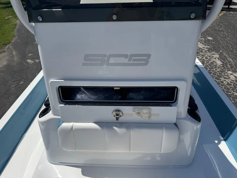 Slide: The Image of 2025 SCB R24 boat console with storage compartment and sleek design. - 13