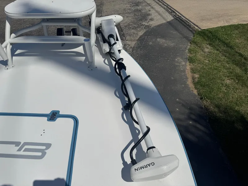 Slide: The Image of 2025 SCB R24 boat with Garmin equipment on deck, parked on pavement. - 31