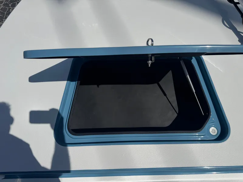 Slide: The Image of Open hatch on 2025 SCB R24 boat deck, showing storage compartment. - 34