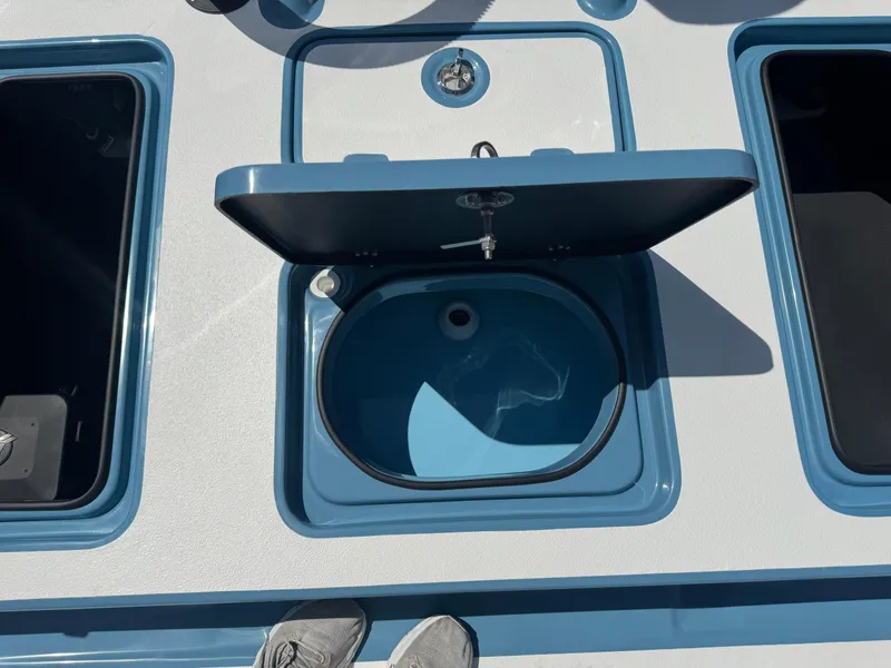 Slide: The Image of 2025 SCB R24 boat with open storage compartment and blue interior. - 38