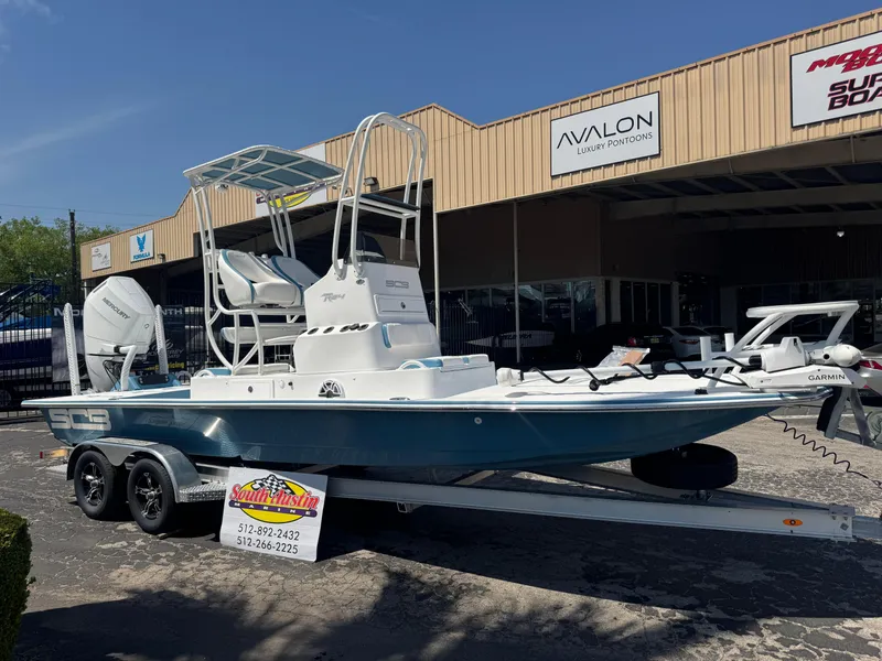Slide: The Image of 2025 SCB R24 boat on trailer outside dealership, featuring dual engines and elevated seating. - 40