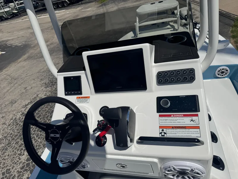 Slide: The Image of 2025 SCB R24 boat dashboard with steering wheel, touchscreen, and control panel. - 7