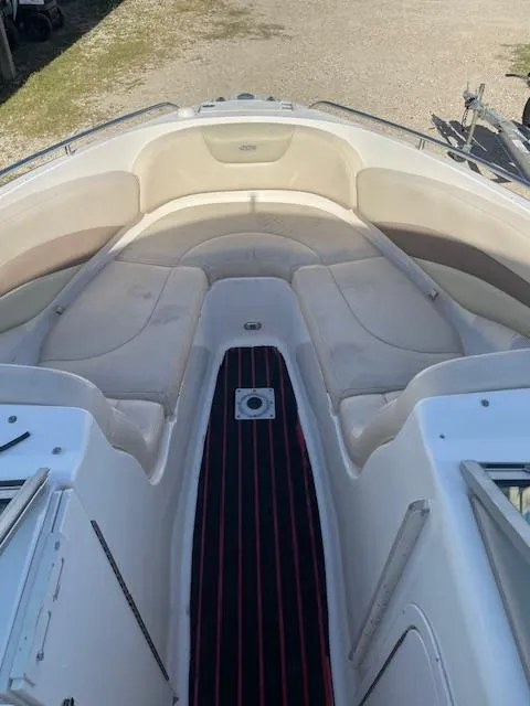 Slide: The Image of 2006 Chaparral 256 SSi boat interior with cushioned seating and striped flooring. - 10