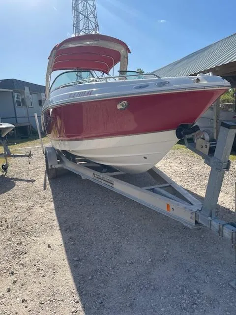 Slide: The Image of 2006 Chaparral 256 SSi boat on trailer, red and white exterior, sunny day. - 12