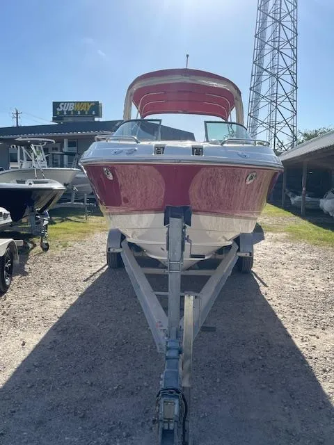 Slide: The Image of 2006 Chaparral 256 SSi boat on trailer, red and white, parked outdoors. - 2