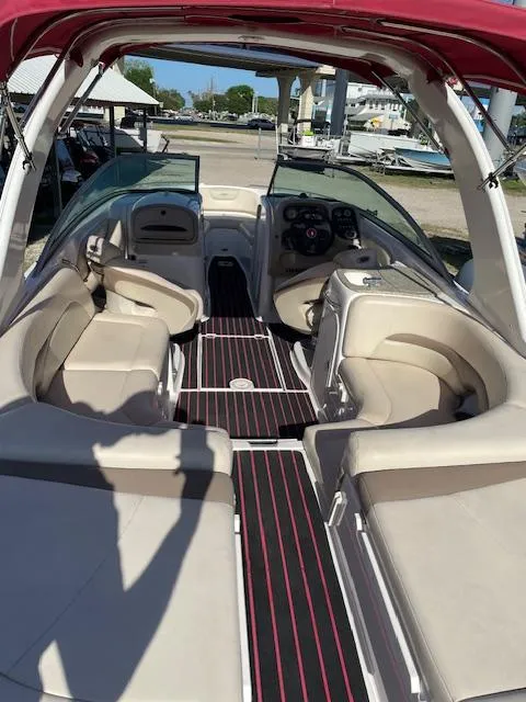 Slide: The Image of 2006 Chaparral 256 SSi boat interior with beige seating and red accents. - 7