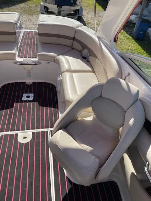 Slide: The Image of 2006 Chaparral 256 SSi boat interior with beige seating and striped flooring. - 9