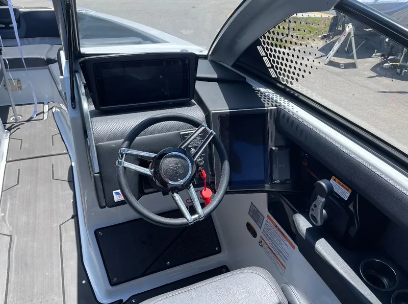 Slide: The Image of 2023 Scarab 285 ID boat cockpit with steering wheel and control panels. - 5