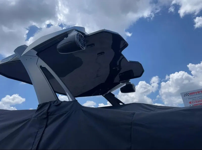Slide: The Image of 2023 Scarab 285 ID boat with sleek design against a cloudy sky backdrop. - 7