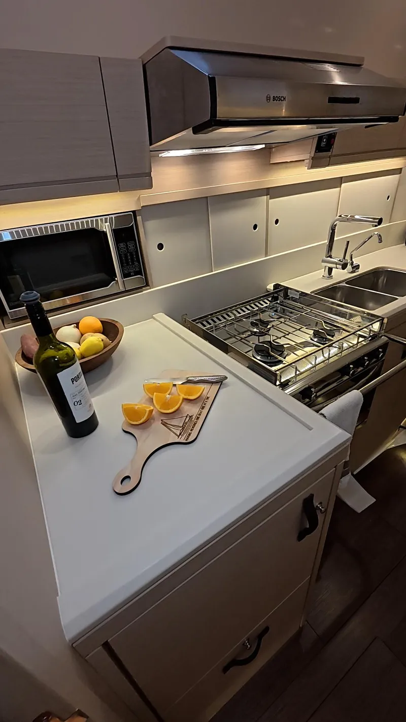 Slide: The Image of Modern kitchen interior of 2021 Jeanneau 54 yacht with sleek cabinetry and appliances. - 13