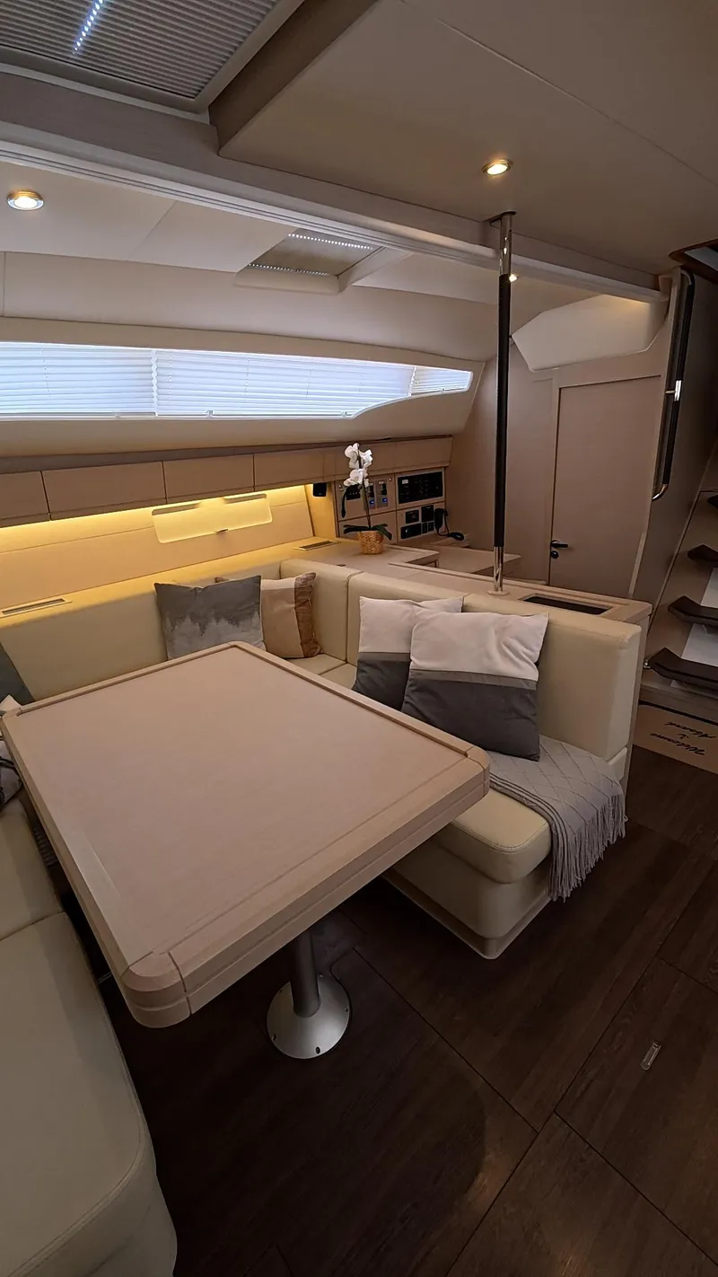 Slide: The Image of Jeanneau 54 sailboat deck with winches, 2021 model, sailing on calm blue sea. - 21