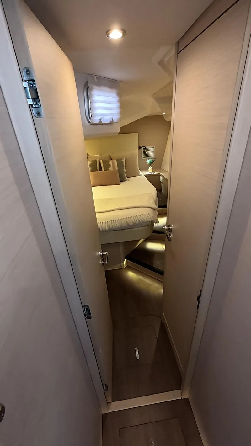 Slide: The Image of Modern kitchen area in a 2021 Jeanneau 54 yacht, featuring sleek cabinetry and appliances. - 28