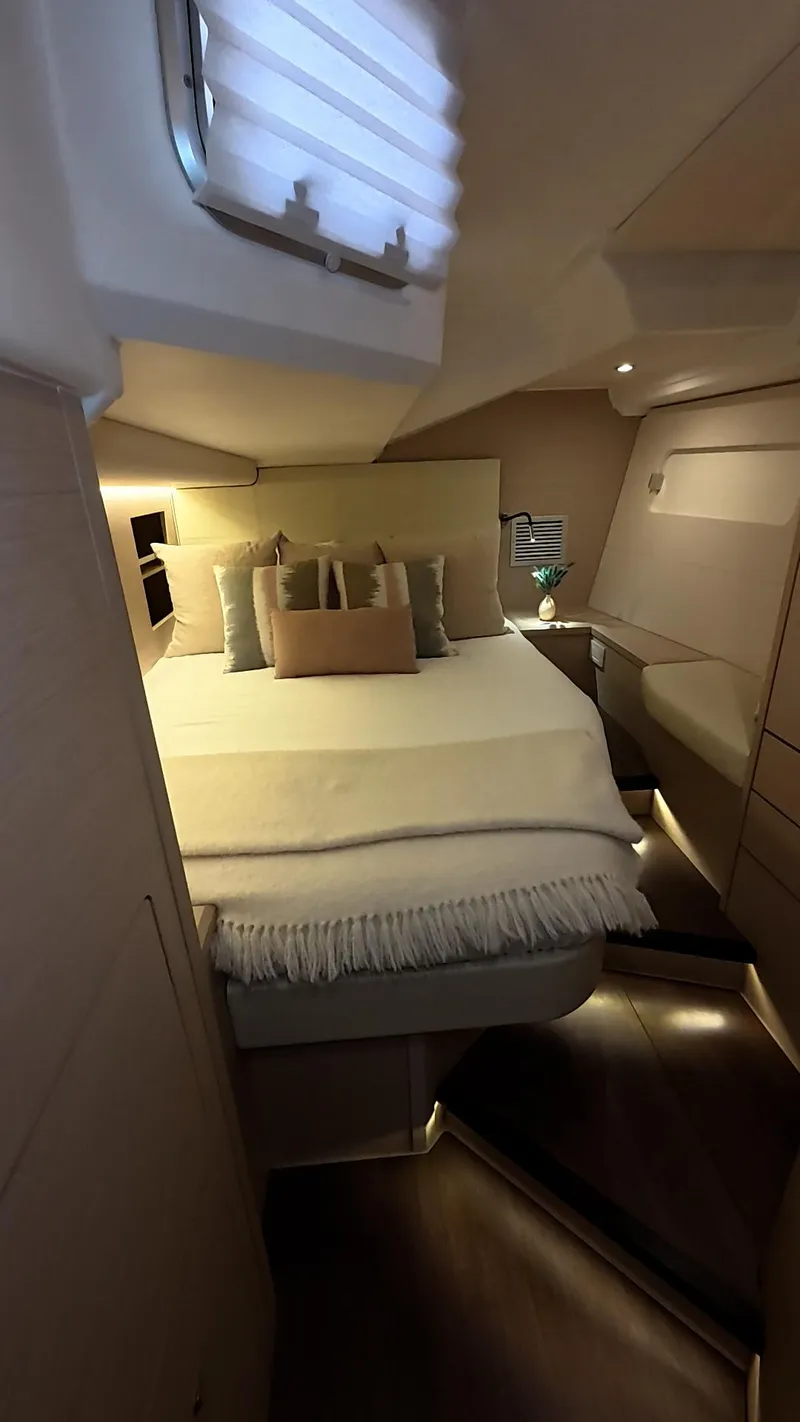 Slide: The Image of Wine cooler in a 2021 Jeanneau 54 yacht, featuring multiple bottles and adjustable temperature settings. - 29