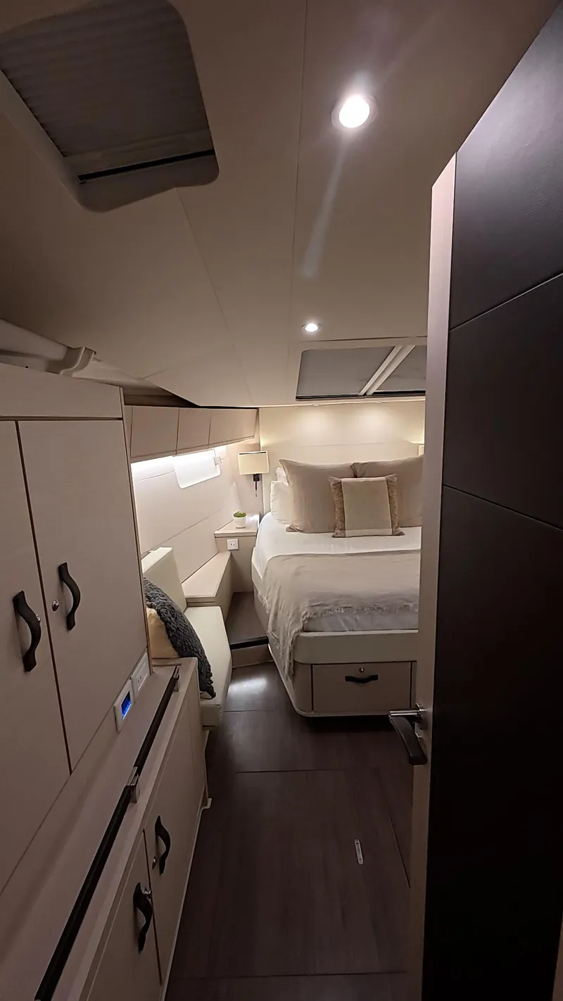 Slide: The Image of Luxurious interior cabin of 2021 Jeanneau 54 yacht, featuring cozy bedding and modern design. - 31