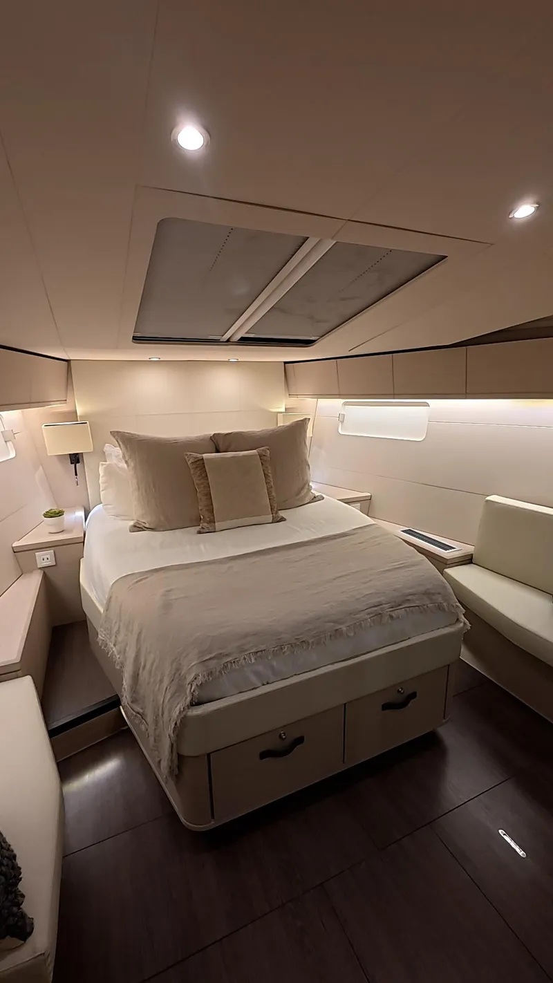 Slide: The Image of Luxurious cabin interior of 2021 Jeanneau 54 yacht with cozy bedding and ambient lighting. - 32