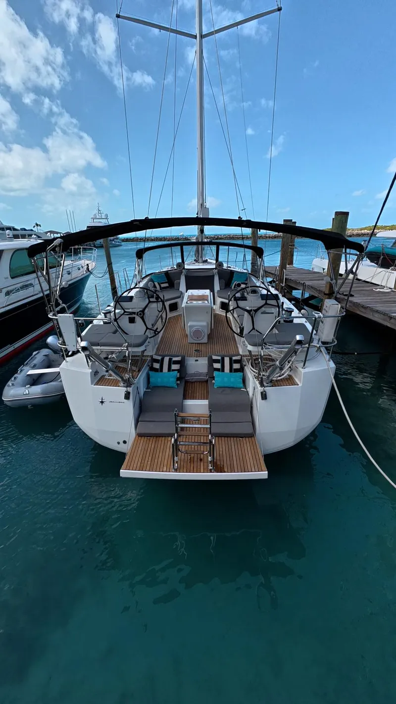 Slide: The Image of Jeanneau 54 yacht docked with inflatable dinghy, clear turquoise water, 2021 model. - 42