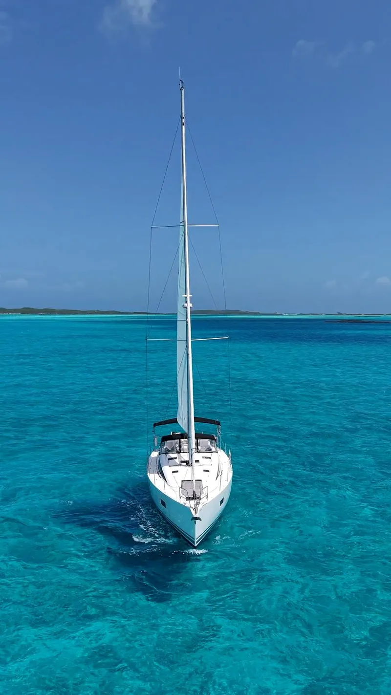 Slide: The Image of 2021 Jeanneau 54 sailing on calm blue ocean under clear sky. - 48