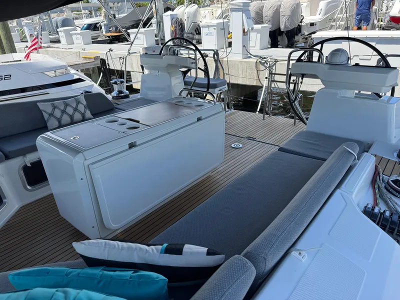 Slide: The Image of Jeanneau 54 yacht, 2021 model, docked at marina with sunbathing area. - 52