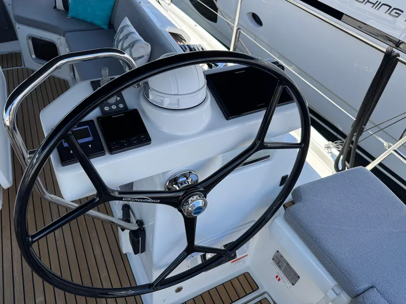 Slide: The Image of Mast of a 2021 Jeanneau 54 sailboat against a clear blue sky. - 53