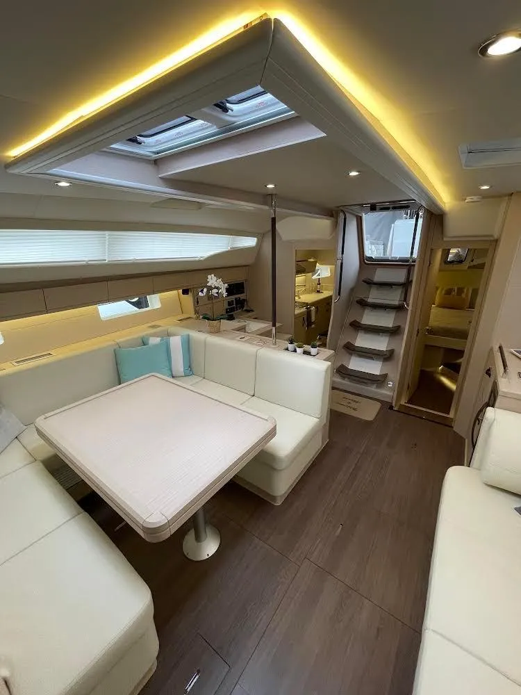 Slide: The Image of 2021 Jeanneau 54 yacht with dual steering wheels and spacious deck, docked at marina. - 8