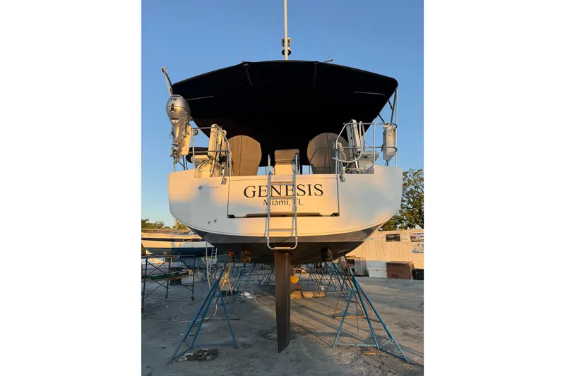 Slide: The Image of 2021 Jeanneau 54 sailboat on dry dock under clear blue sky. - 84