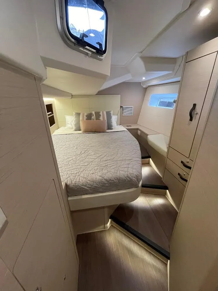 Slide: The Image of Interior of 2021 Jeanneau 54 yacht, featuring a modern bathroom and cozy seating area. - 9