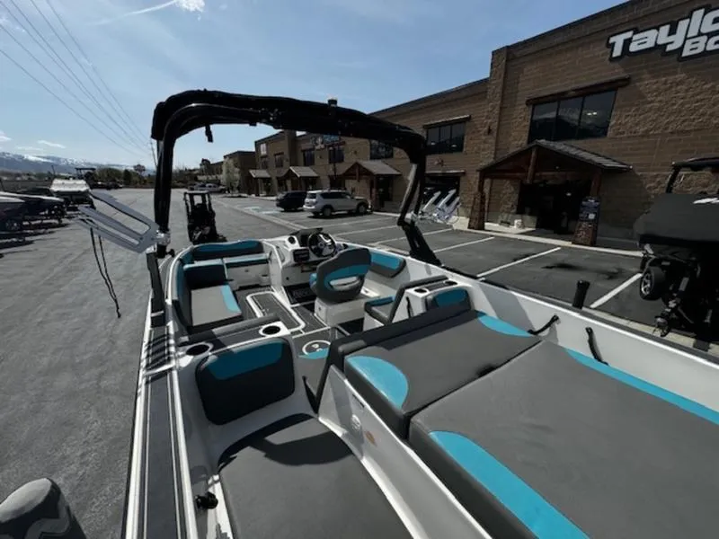 Slide: The Image of 2018 Heyday WT-2 boat with blue and gray seating, parked outside a dealership. - 11