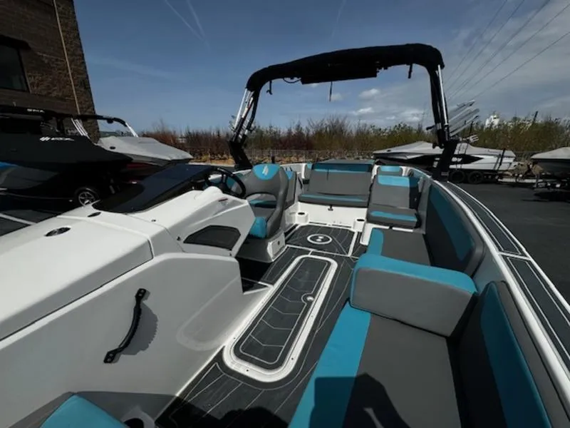 Slide: The Image of 2018 Heyday WT-2 boat interior with blue and gray seating, docked outdoors. - 12