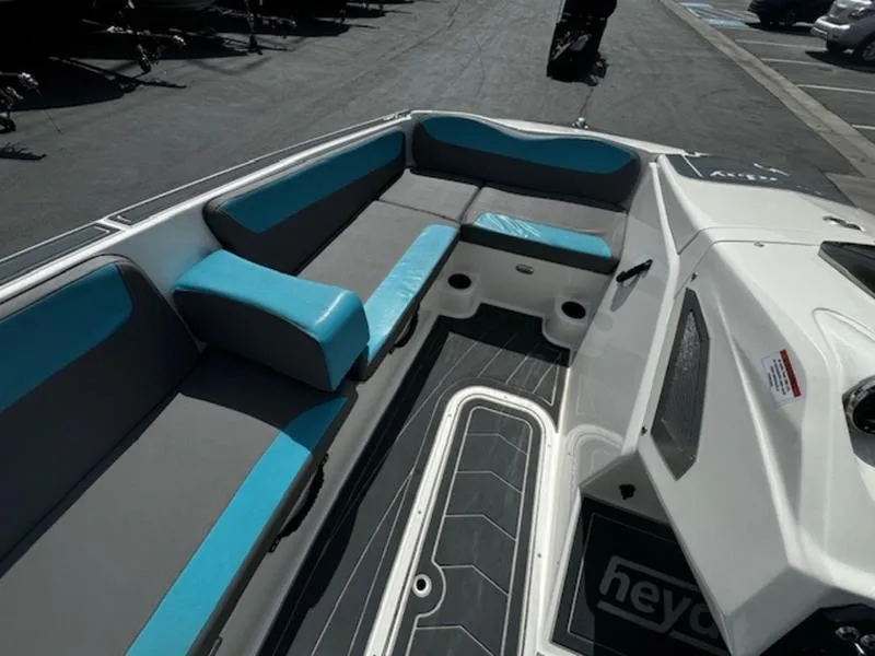 Slide: The Image of 2018 Heyday WT-2 boat interior with gray and blue seating, docked outdoors. - 13