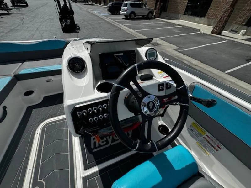 Slide: The Image of 2018 Heyday WT-2 boat dashboard with steering wheel and control panel in a parking lot. - 14