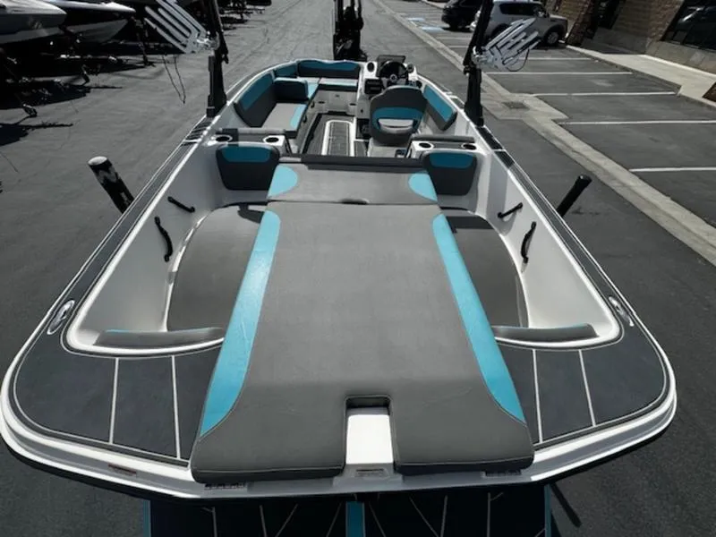 Slide: The Image of 2018 Heyday WT-2 boat interior with gray and blue seating, docked in a parking area. - 8