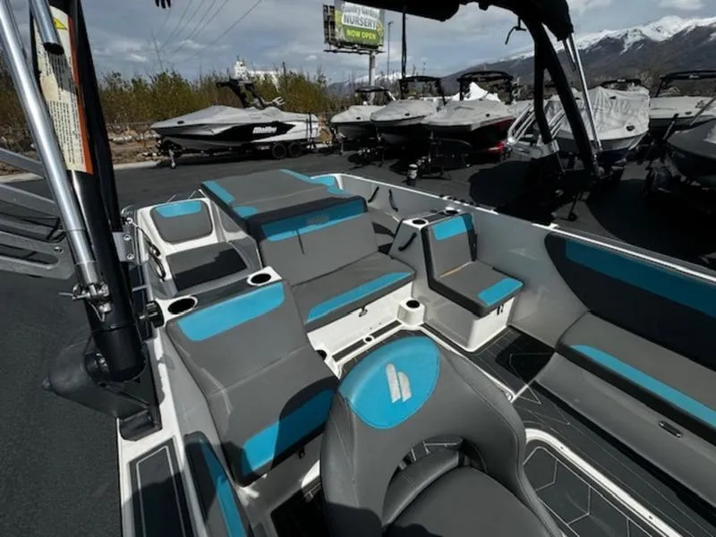 Slide: The Image of 2018 Heyday WT-2 boat interior with gray and blue seating, docked among other boats. - 9