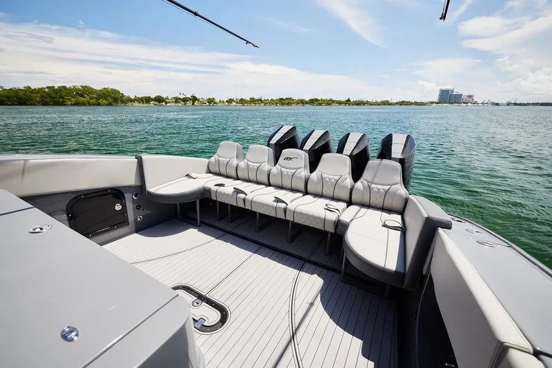 Slide: The Image of 2025 Midnight Express 43' Open boat with spacious seating on calm waters. - 16