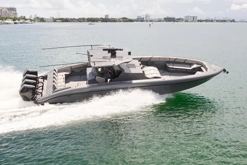 Slide: The Image of 2025 Midnight Express 43' Open boat cruising on clear waters. - 2