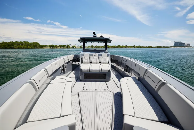 Slide: The Image of 2025 Midnight Express 43' Open boat on calm water, featuring spacious seating and sleek design. - 7
