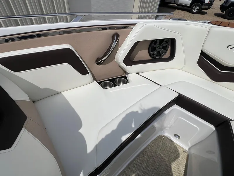 Slide: The Image of Luxurious seating area in a 2015 Monterey 218 Super Sport boat, featuring cup holders and speaker. - 11