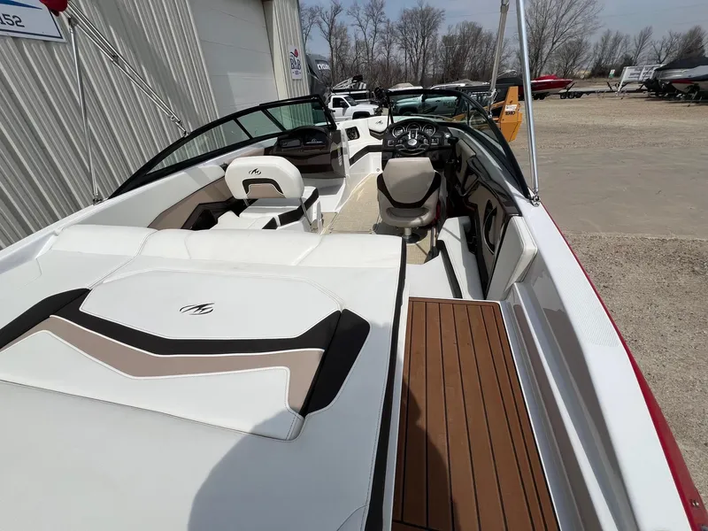 Slide: The Image of 2015 Monterey 218 Super Sport boat interior with white seating and wood accents. - 17