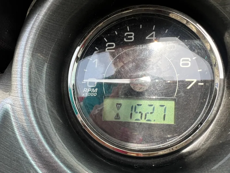 Slide: The Image of Close-up of a 2015 Monterey 218 Super Sport tachometer displaying 152.7 hours. - 18