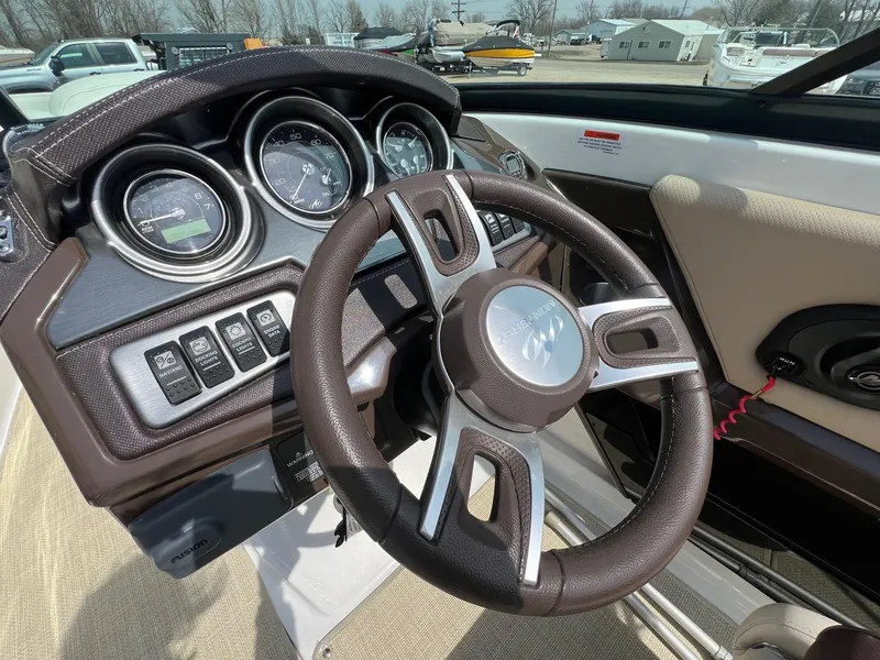 Slide: The Image of Steering wheel and dashboard of a 2015 Monterey 218 Super Sport boat. - 22