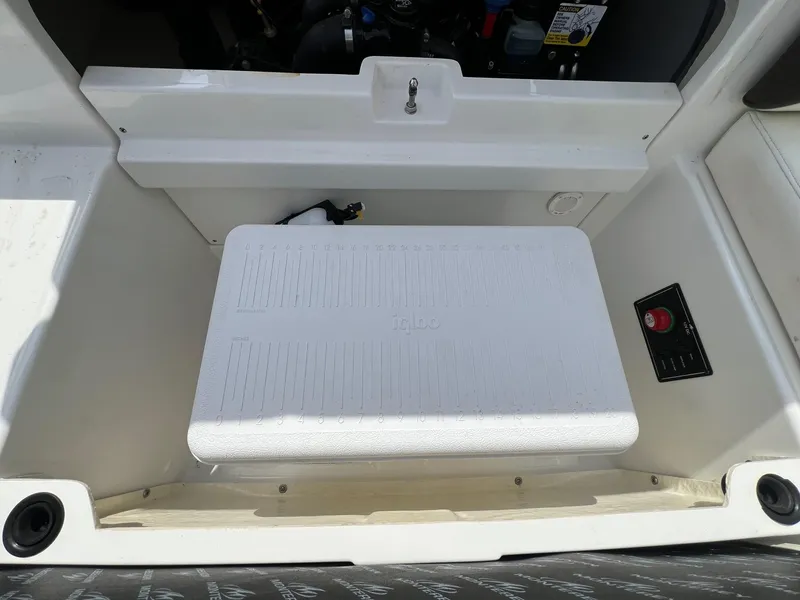 Slide: The Image of Storage compartment in a 2015 Monterey 218 Super Sport boat with an Igloo cooler. - 26
