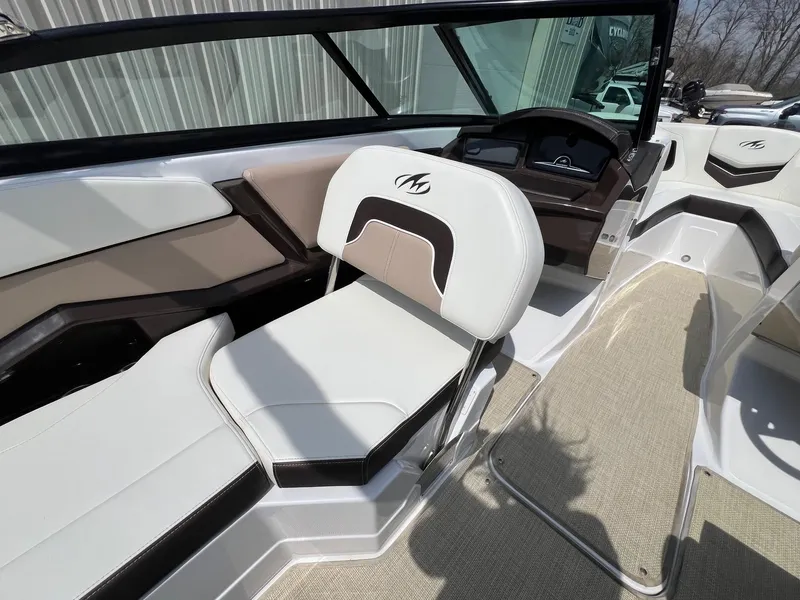 Slide: The Image of 2015 Monterey 218 Super Sport boat interior with white and beige seating. - 28