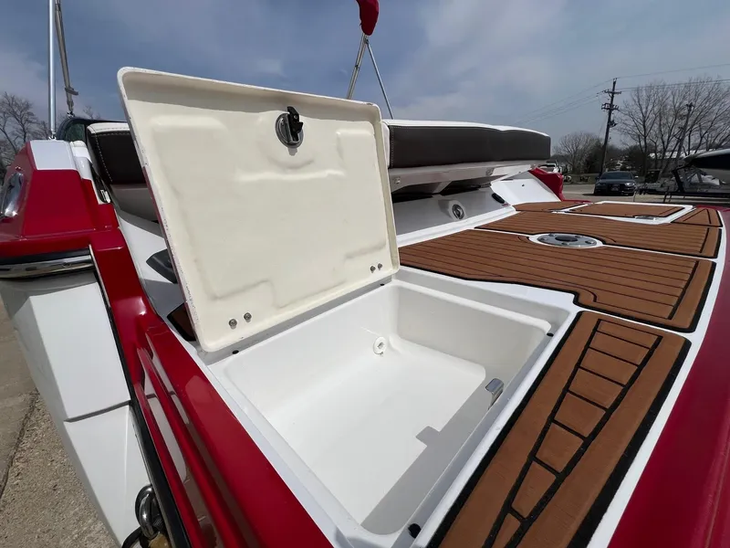 Slide: The Image of 2015 Monterey 218 Super Sport boat with open storage compartment and teak-style decking. - 33