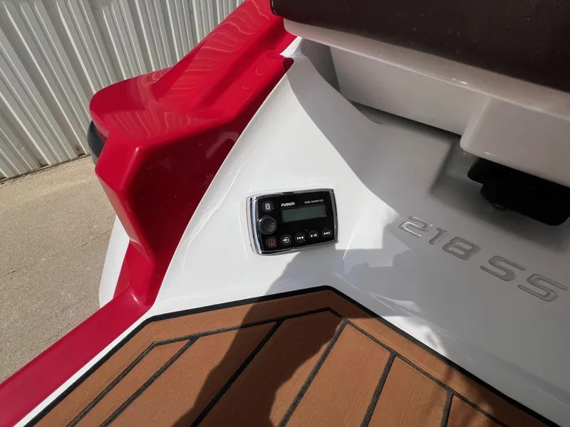 Slide: The Image of 2015 Monterey 218 Super Sport boat with red and white detailing, featuring a control panel. - 36