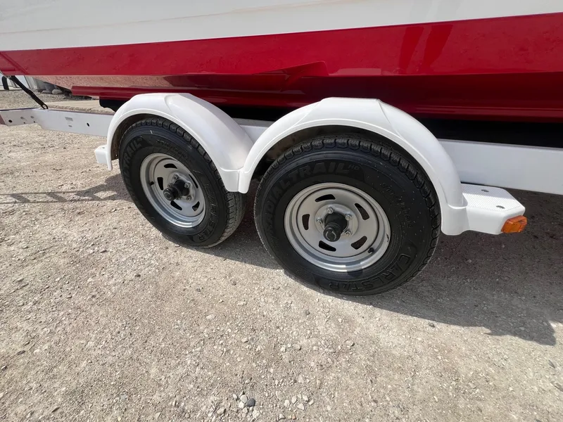 Slide: The Image of 2015 Monterey 218 Super Sport trailer with dual wheels on gravel surface. - 37