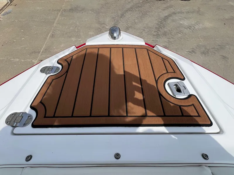 Slide: The Image of 2015 Monterey 218 Super Sport boat deck with wood finish and metal fixtures. - 9