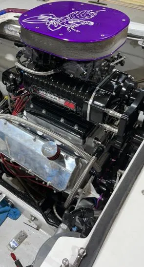 Slide: The Image of High-performance engine in a 1999 Skater 32B, featuring a purple air filter cover. - 11