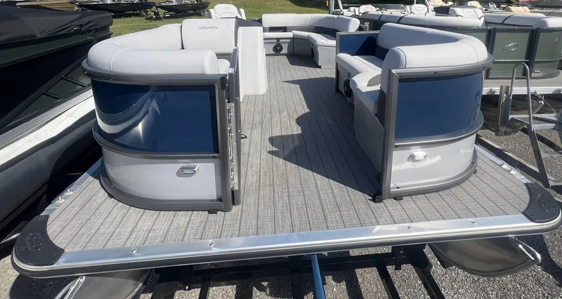Slide: The Image of 2024 Bentley Pontoons Legacy 200 Cruise, spacious deck with modern seating, outdoor setting. - 5