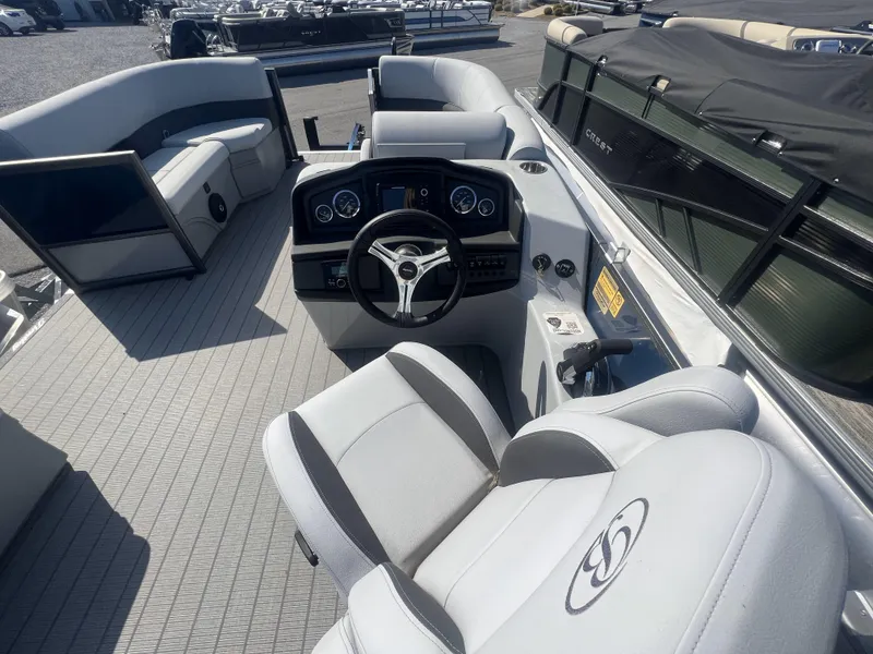 Slide: The Image of 2024 Bentley Pontoons Legacy 200 Cruise interior with steering console and seating. - 8